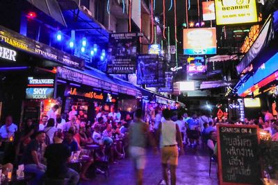 Bangkok street filled with people going to gay bars