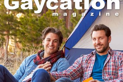 cover of gaycation magazine with two men holding hands in front of a camping tent