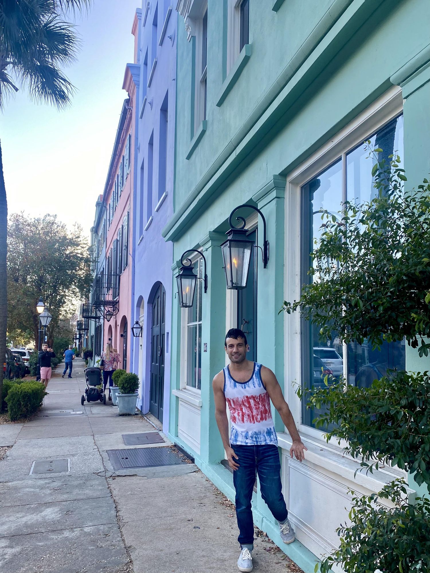 Young man standing in front of colorful buildings