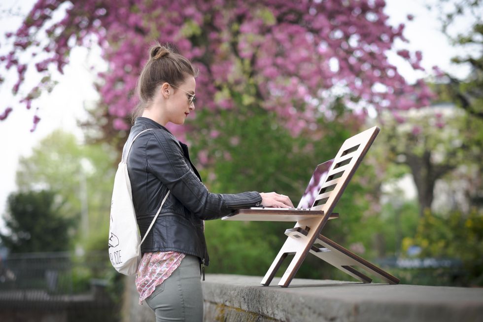young woman on laptop outdoors