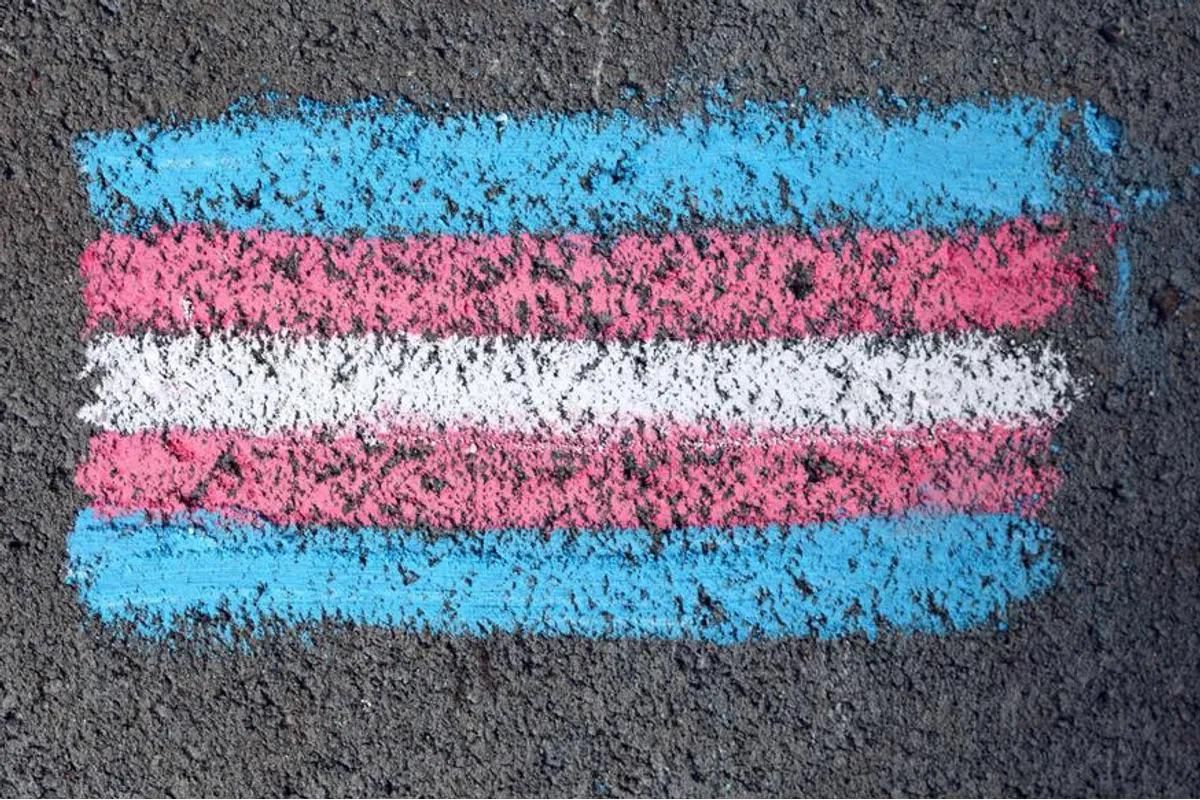 Chalk drawing of trans flag on sidewalk