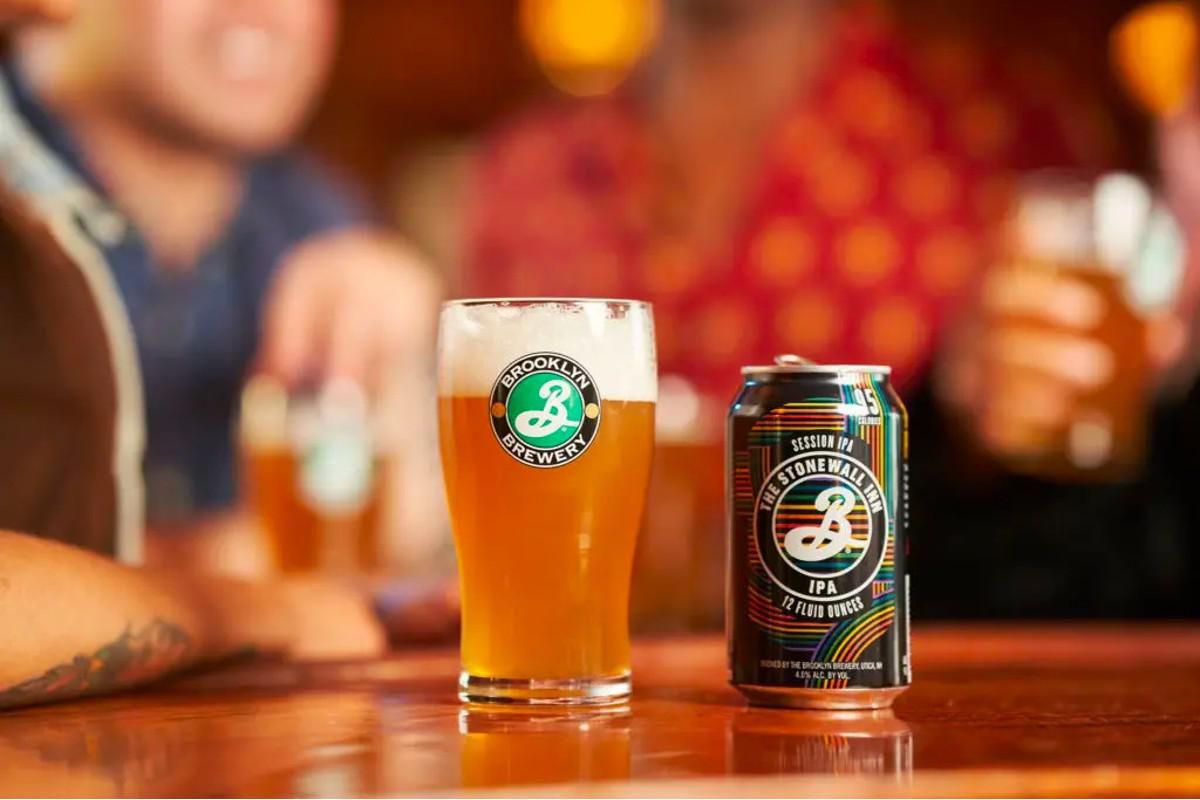 can of Stonewall Inn IPA sitting on a bar next to a pint of beer from Brooklyn Brewery.