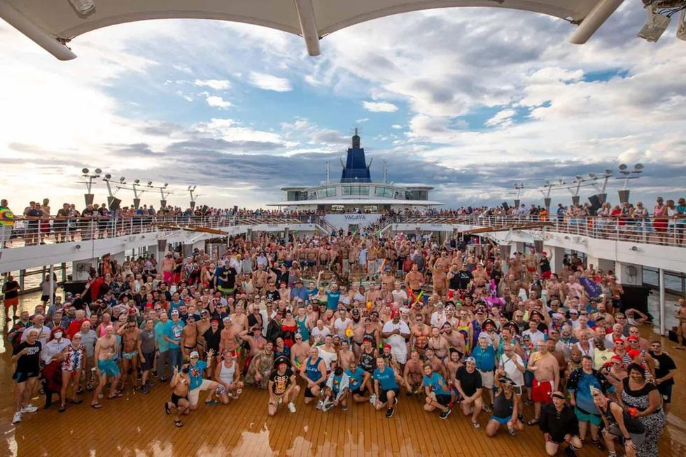 group of vacationers taking a group photo on Celebrity's Millennium ship.