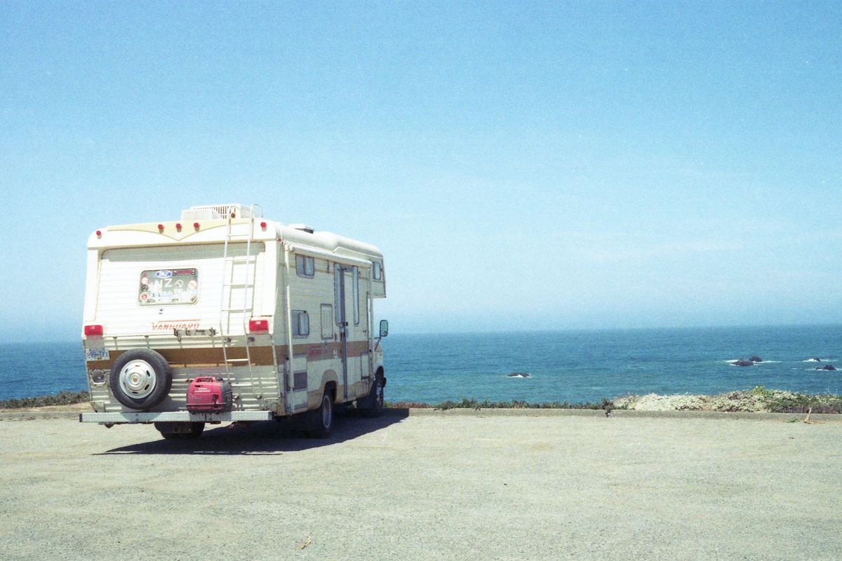 white and blue van on beach during daytime.