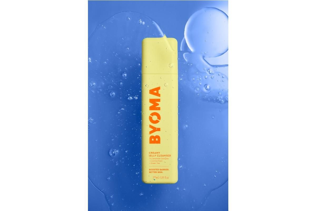 Bottle of BYOMA Creamy Jelly Cleanser against a blue background with watermarks on it.