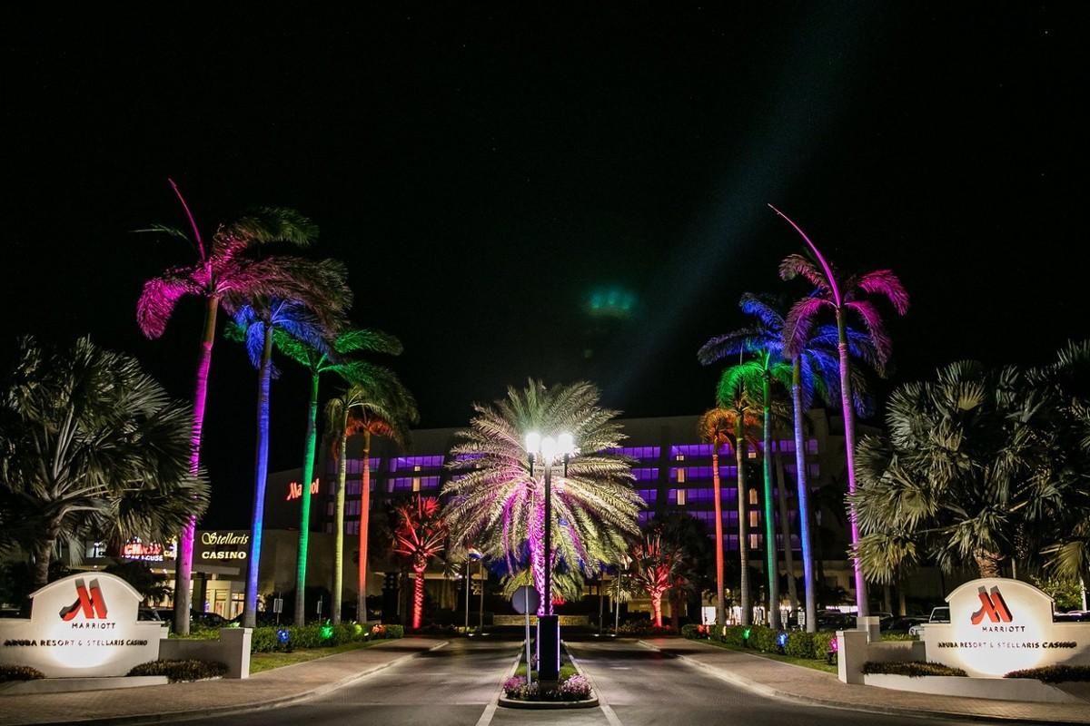 Marriott entranced lined with rainbow colored lighted palm trees.