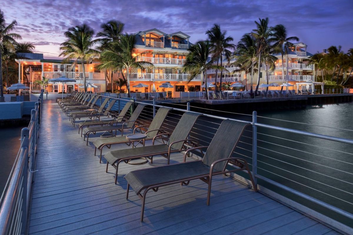 nighttime view of Playa Largo Resort & Spa with lounge chairs lined up on a deck.