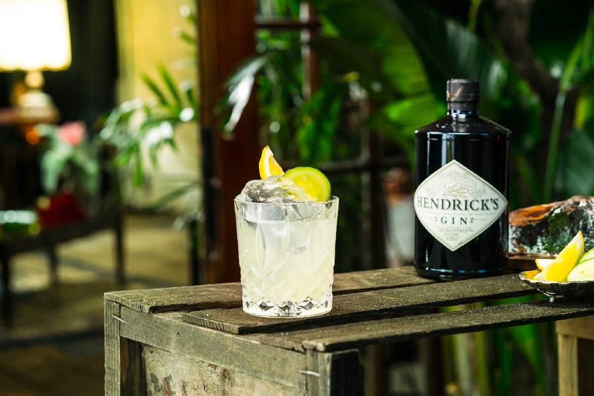Hendrick's Gin Cucumber Lemonade cocktail sitting on a wooden crate.