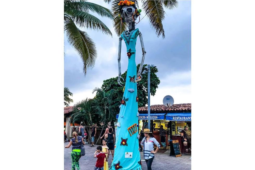 very tall blue dressed Katrina doll statue downtown puerto vallarta