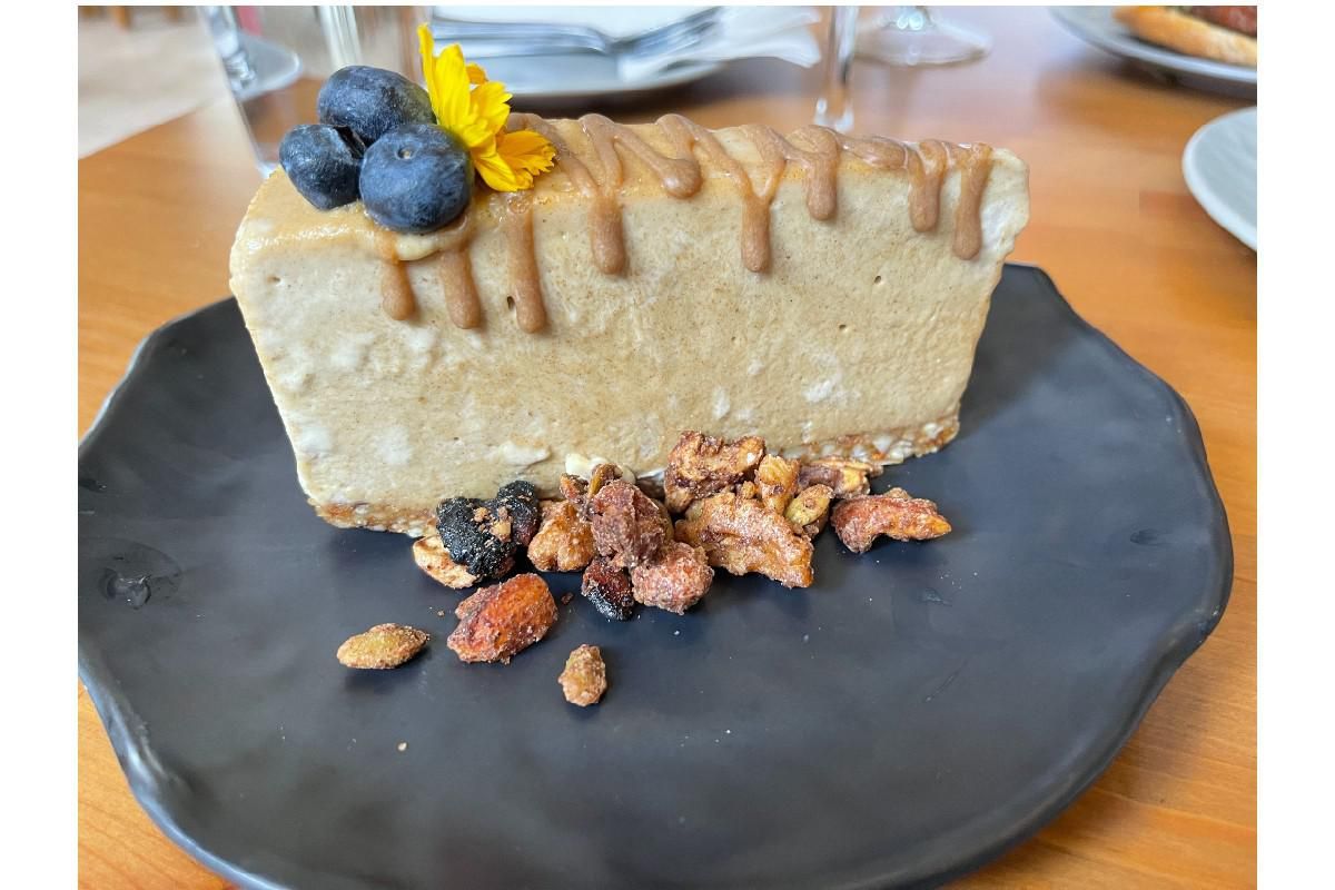 vegan salted caramel cheesecake with candied nuts.