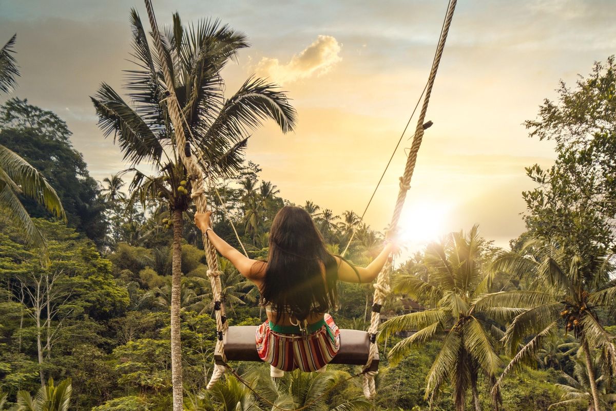 Visitor on jungle swing in Tegalalang Ubud Rice Terraces in Bali.