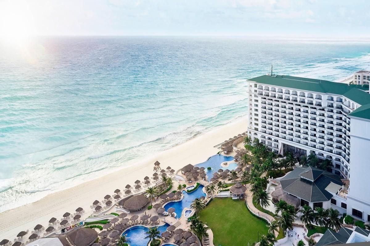 Aerial view of the JW Marriott Canc\u00fan overlooking swimming pools and the Caribbean Sea