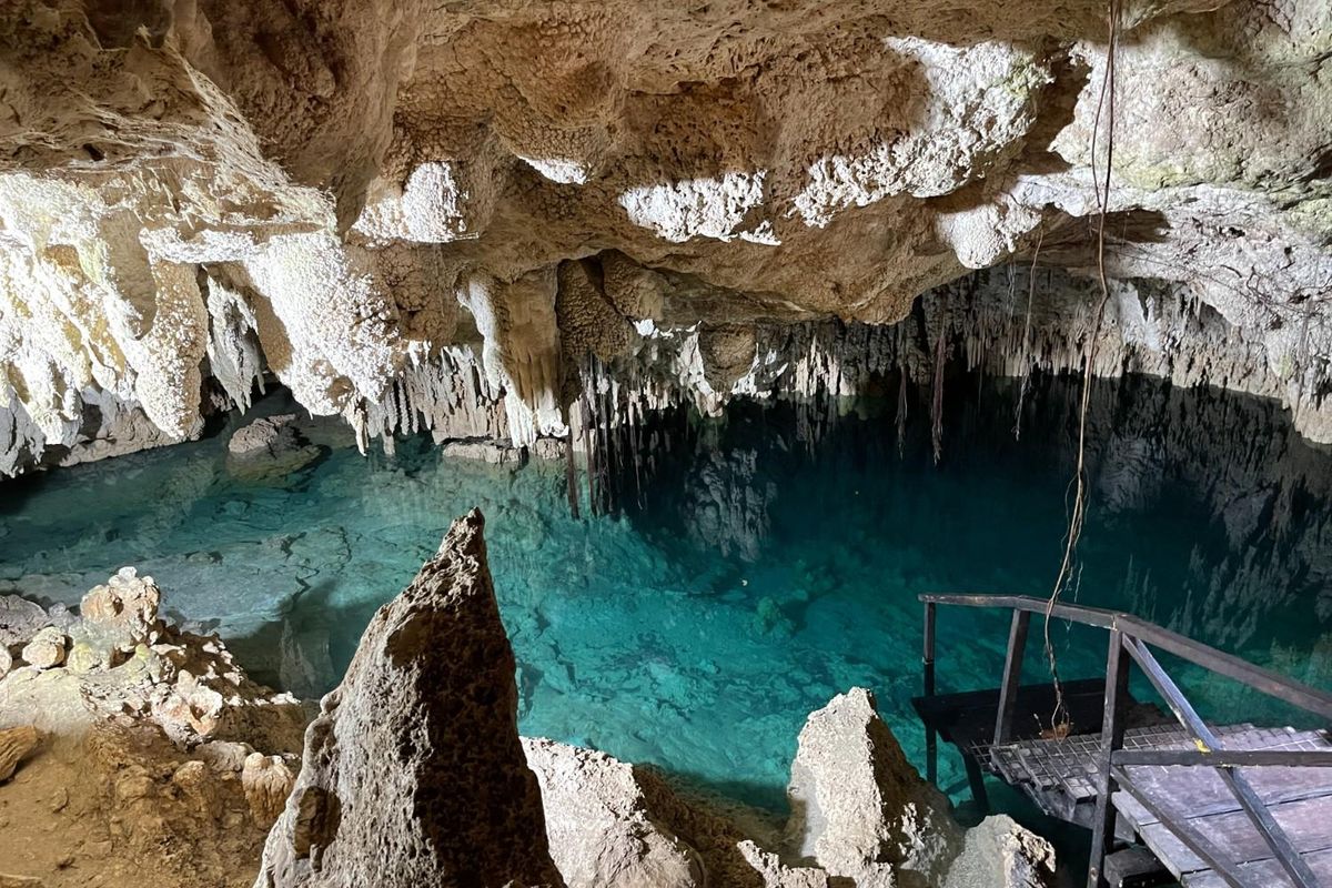 underground cavern cenote with clear bluish green water