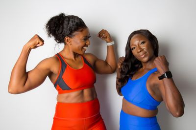 woman in blue sports bra beside woman in blue sports bra