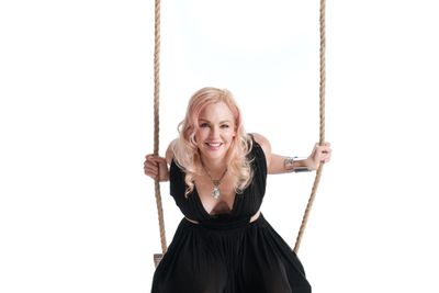 Woman in a dress on a swing