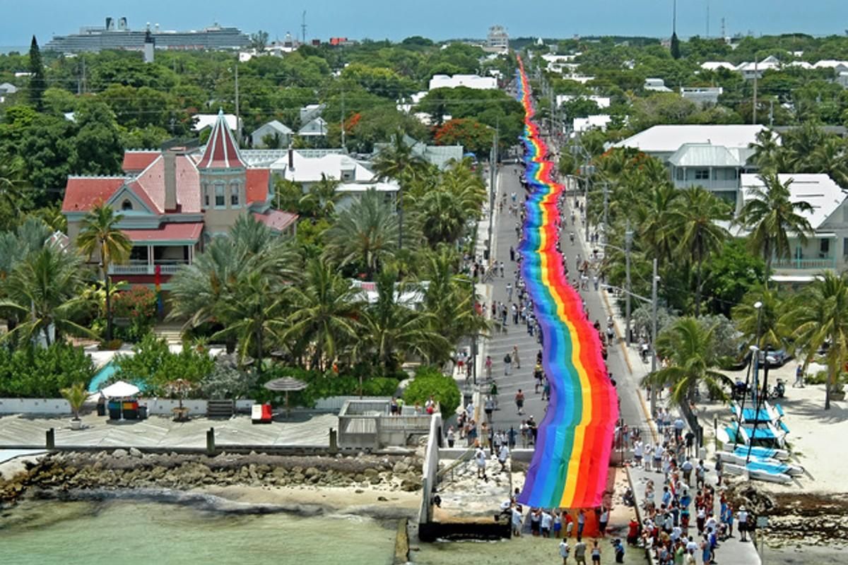 1.25 mile long key west rainbow flag made by Gilbert Baker stretched across the island of Key west.