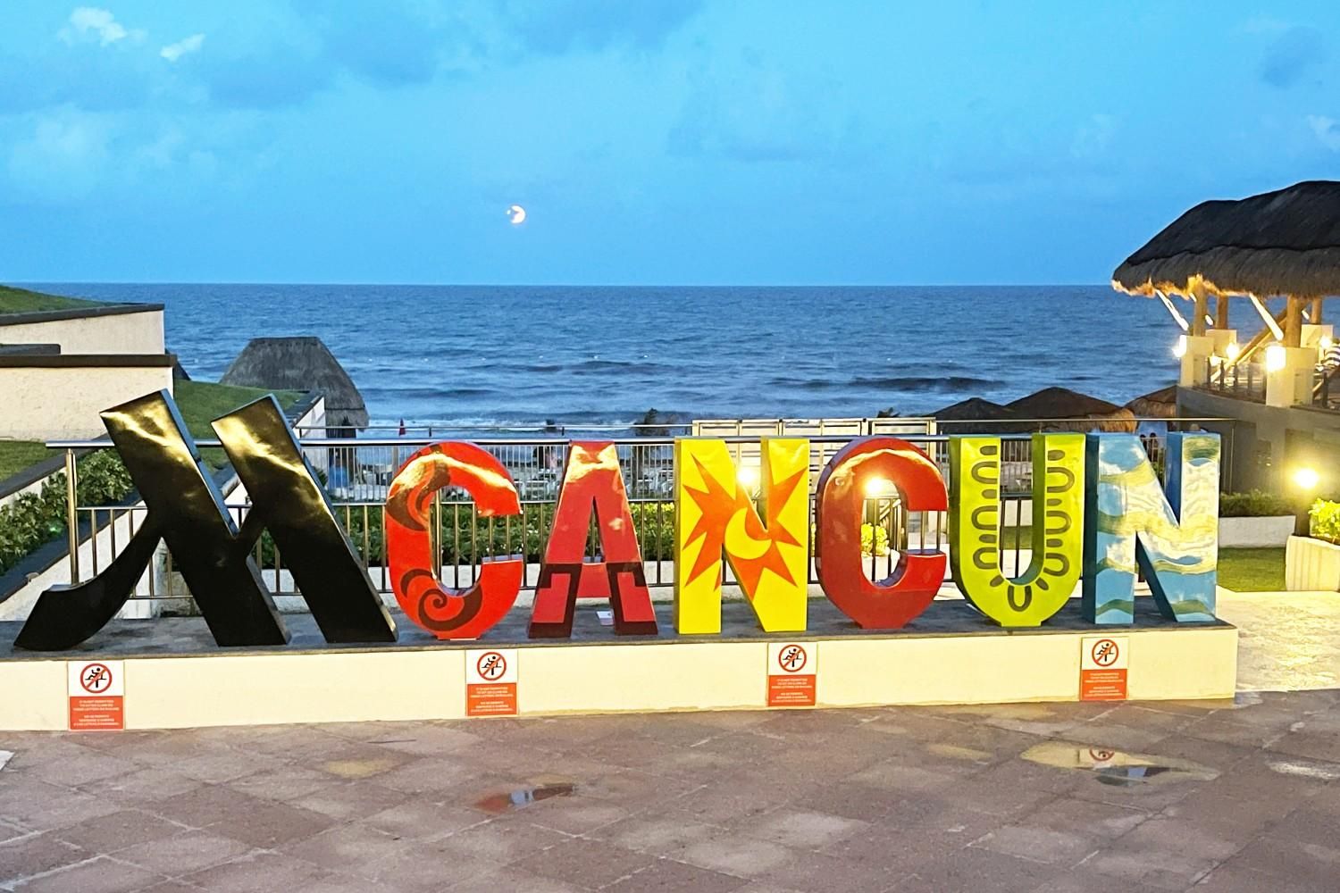 Cancún Mexico sign at the JW Marriott overlooking the Caribbean Sea during a full moon.