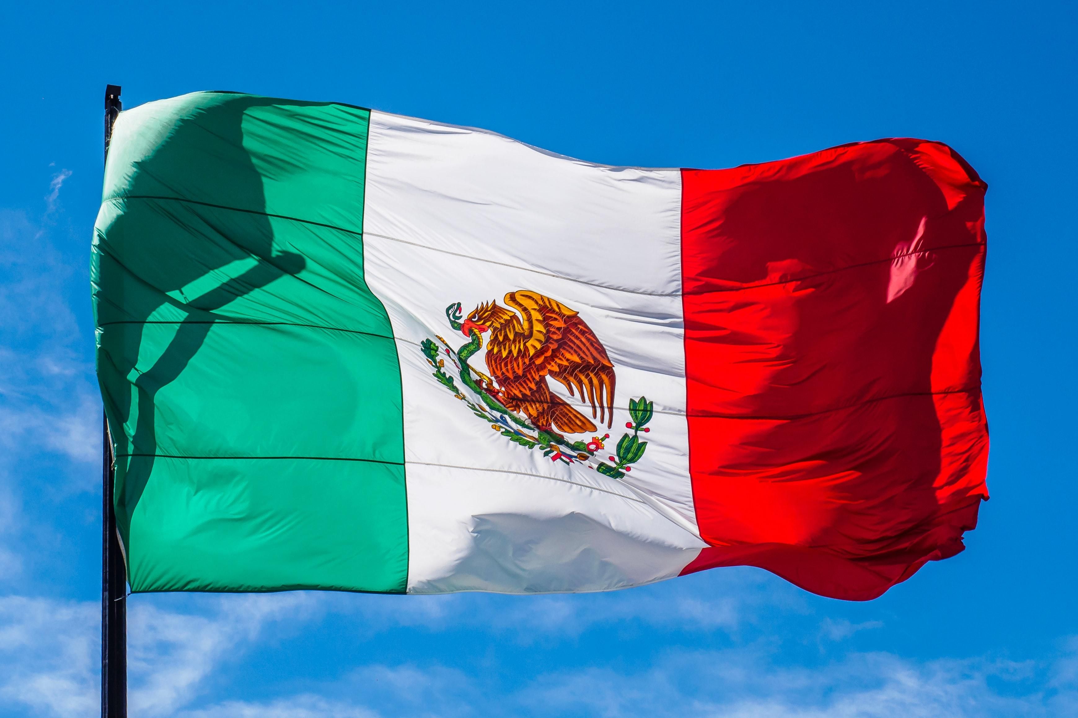 the Mexican flag waving in the wind.