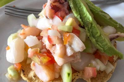 Seafood ceviche with avocado on a tostada shell